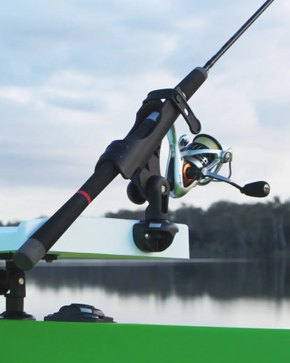 Fishing rod and reel on a boat with a blurred water and sky background